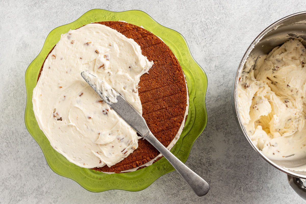 Taste of Home Italian Cream Cake recipe photo of frosting the cake.