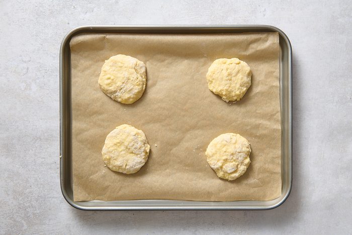 Lemon strawberry shortcakes cut out onto a baking sheet