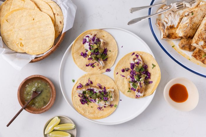 Mahi mahi tacos being assembled.