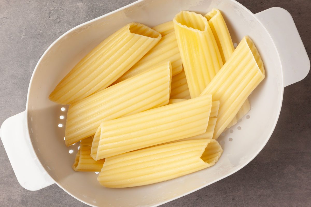 Step 1 of Taste of Home Meaty Manicotti is to cook the manicotti shells according to the package directions, being sure to leave them firm but tender. Drain the shells and rinse them in cold water, then set them aside.