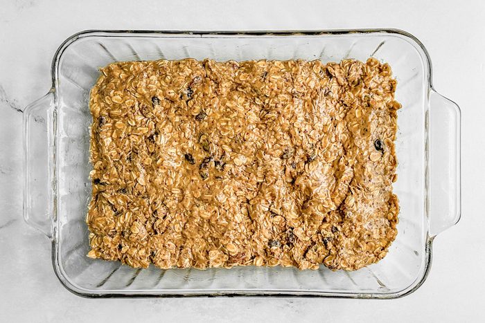 Taste of Home Nut Free Granola Bars in a glass baking dish on a marble surface