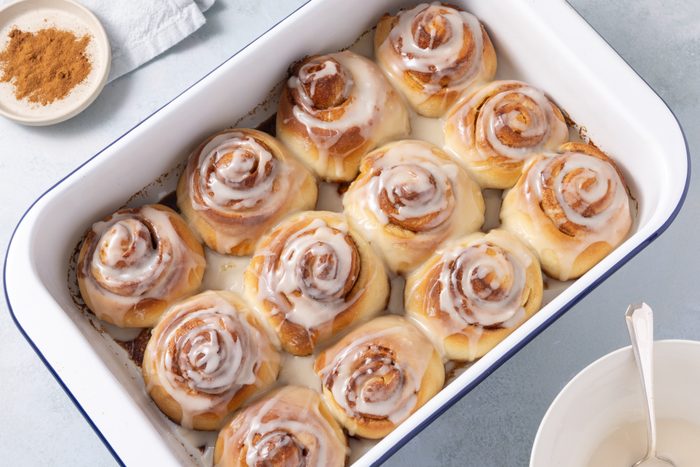 Cinnamon rolls baked and glazed served in baking dish.