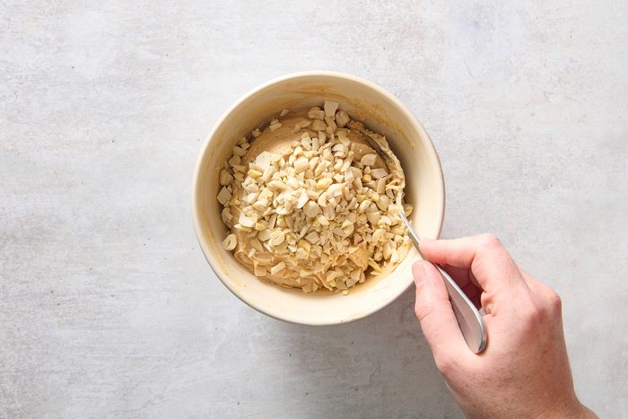 Stirring in the chopped peanuts