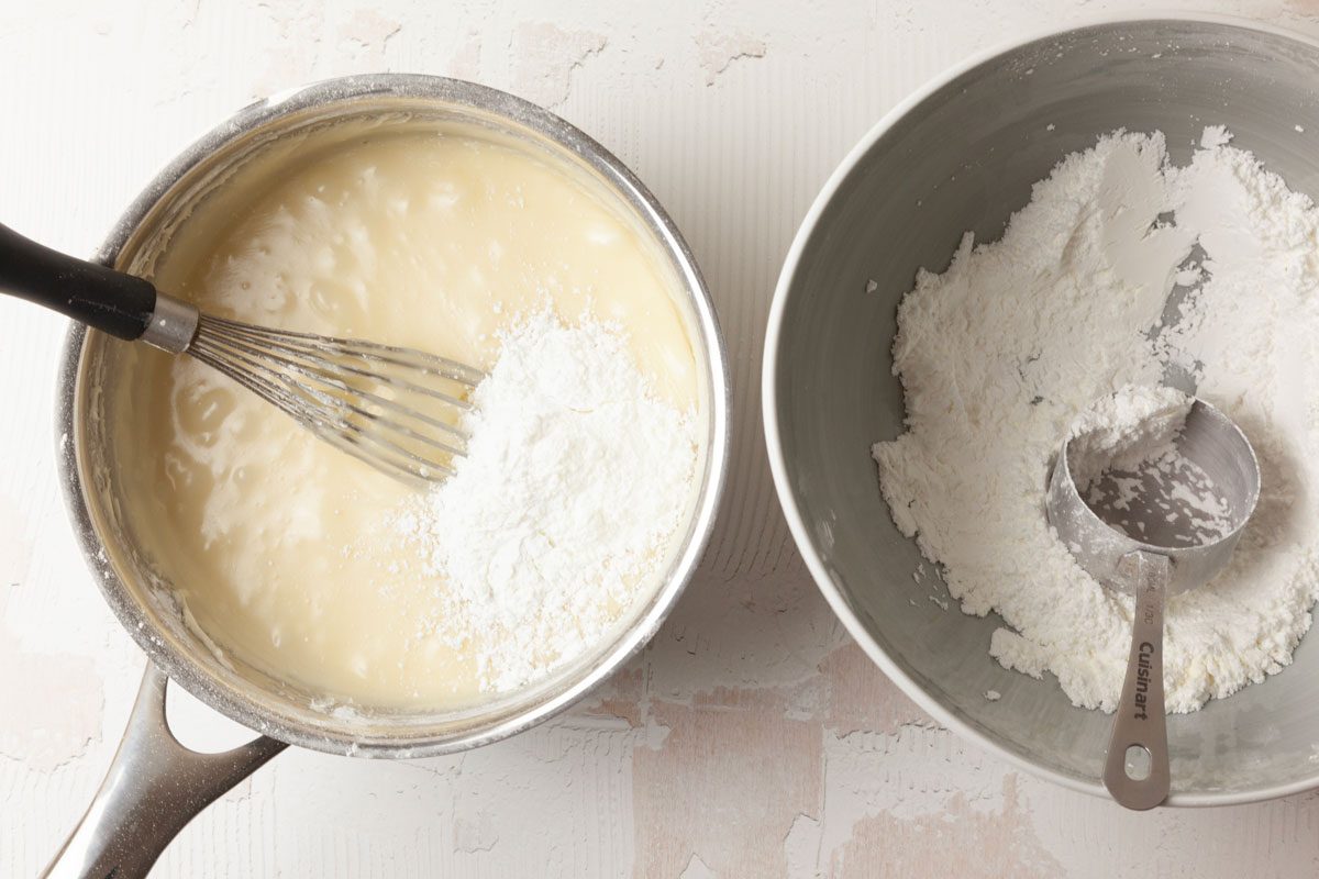 Step 2 of Taste of Home Pecan Logs is to combine ½ cup of the butter with the granulated sugar and corn syrup. Cook and stir the sugar mixture until the sugar is dissolved and it comes to a boil. Stir in the confectioners’ sugar mixture 1/3 at a time, until it’s blended.