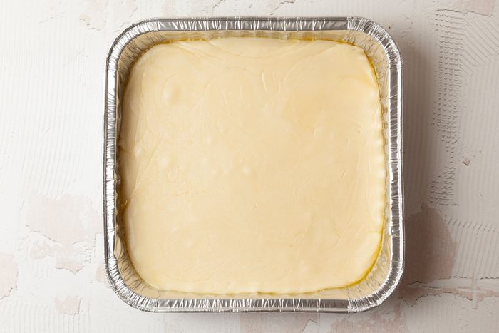 Step 3 of Taste of Home Pecan Logs is to remove the sugar mixture from the heat and stir in the vanilla. Continue stirring as it cools and thickens. The mixture should mound slightly when you drop it from a spoon. Spread the mixture into the buttered pan and let it cool.