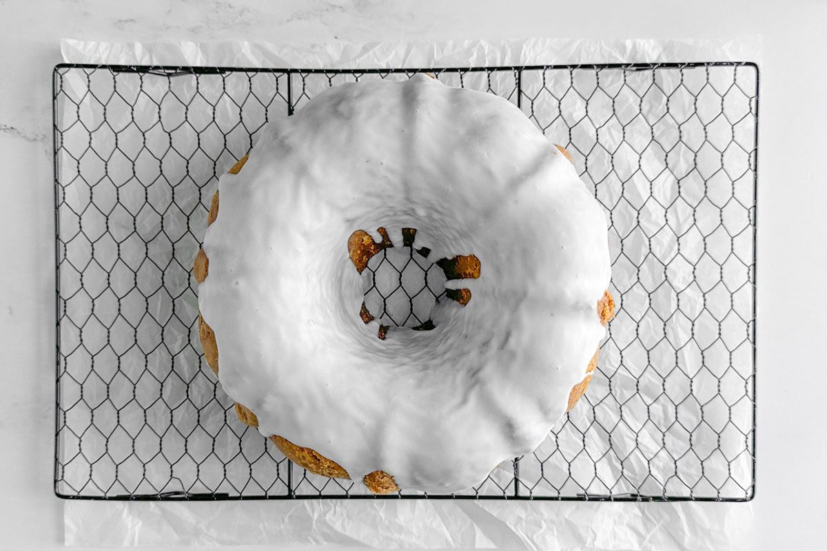 Taste of Home Pistachio Bundt Cake on a wire rack on a marble surface