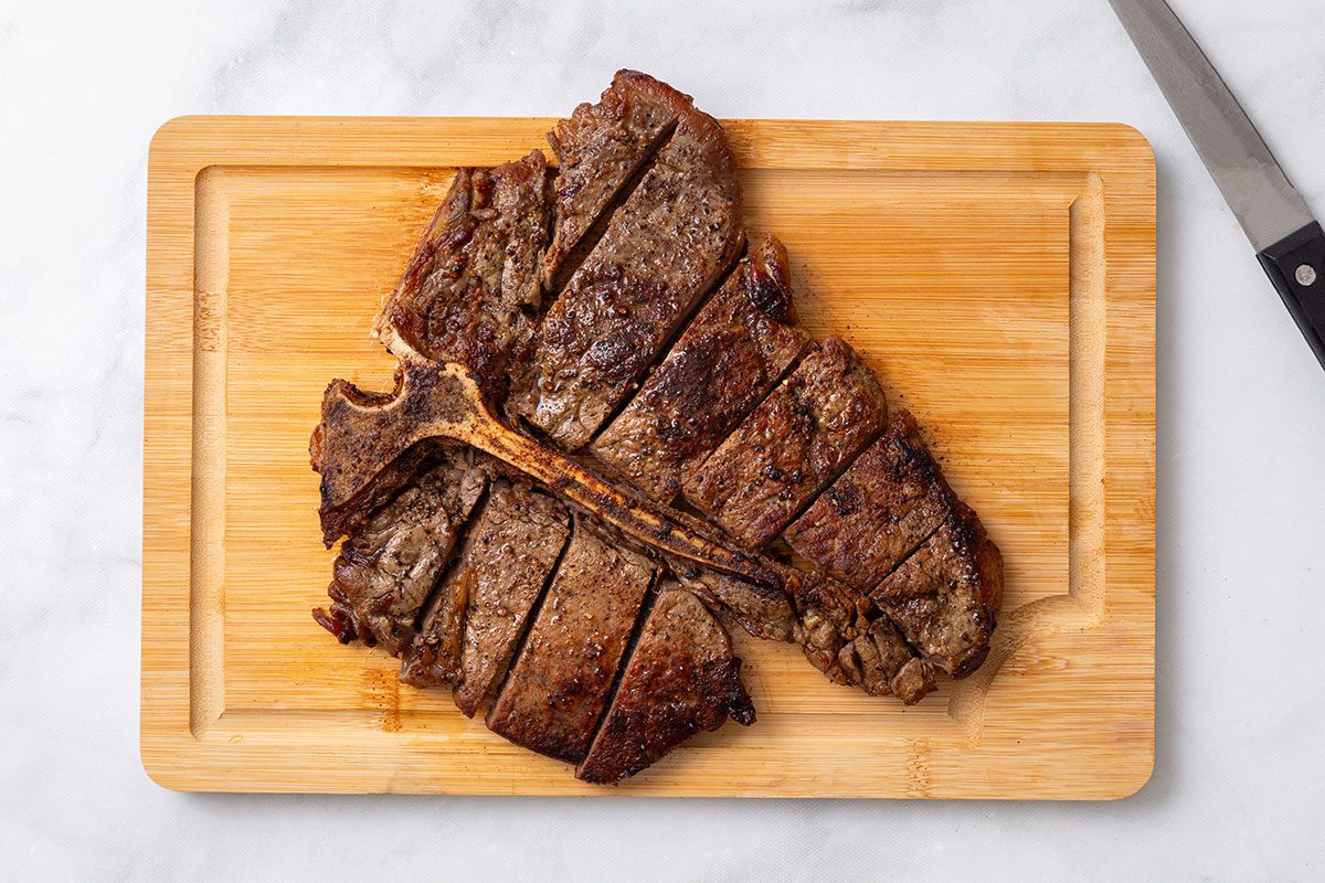 Steak cut into 2 inch pieces for step four of Porterhouse Steak recipe for Taste of Home