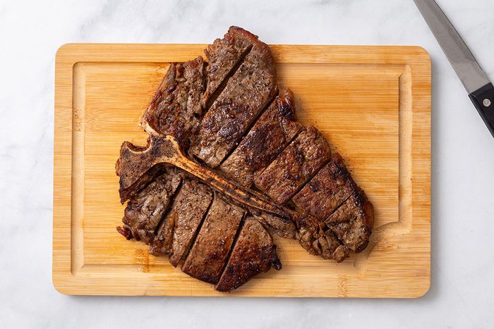 Steak cut into 2 inch pieces for step four of Porterhouse Steak recipe for Taste of Home