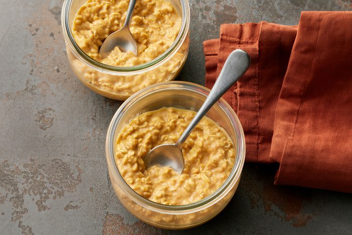 Pumpkin Overnight Oats in two containers with spoon