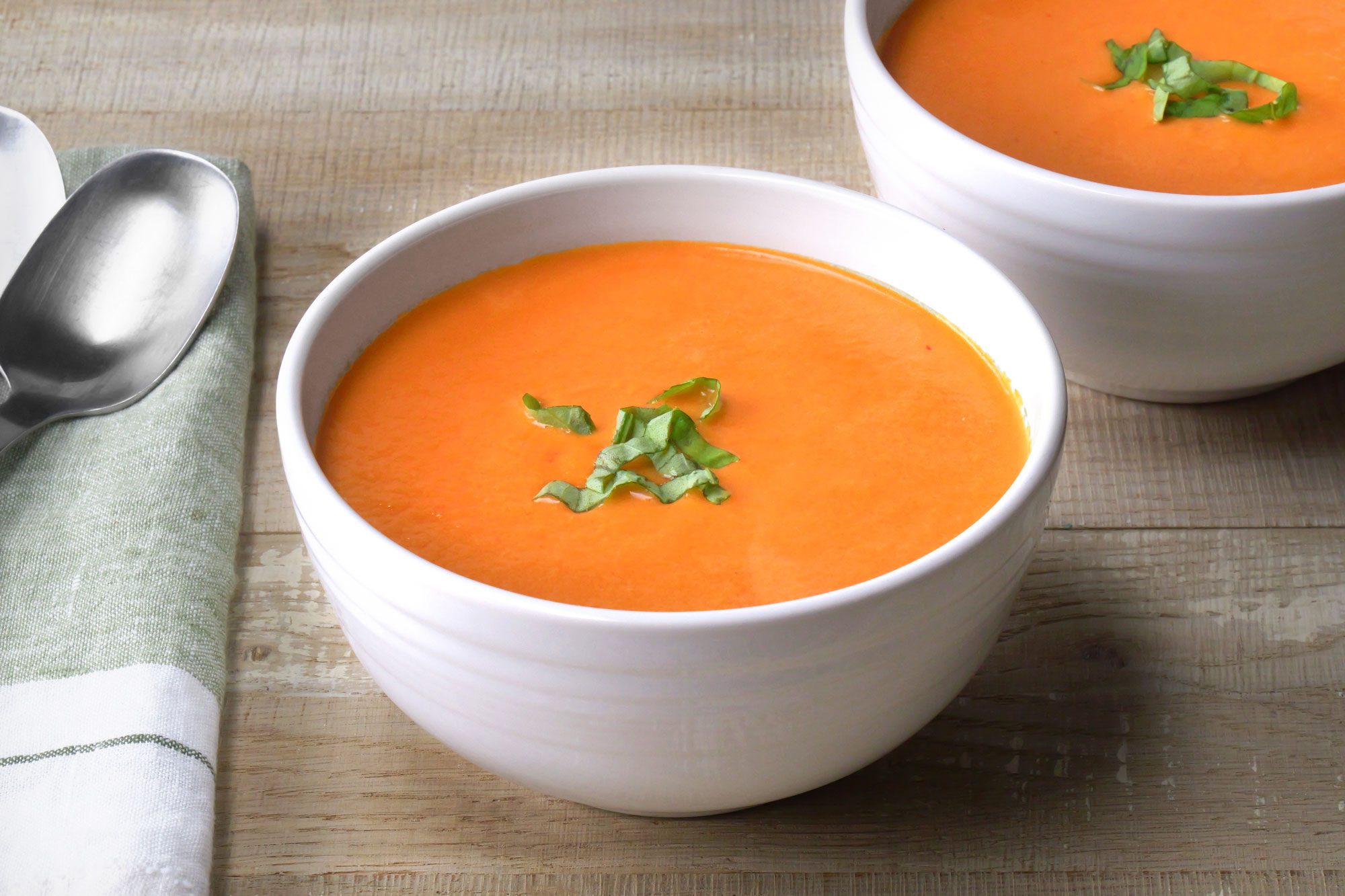 3/4th shot of roasted tomato soup; Wooden Background;