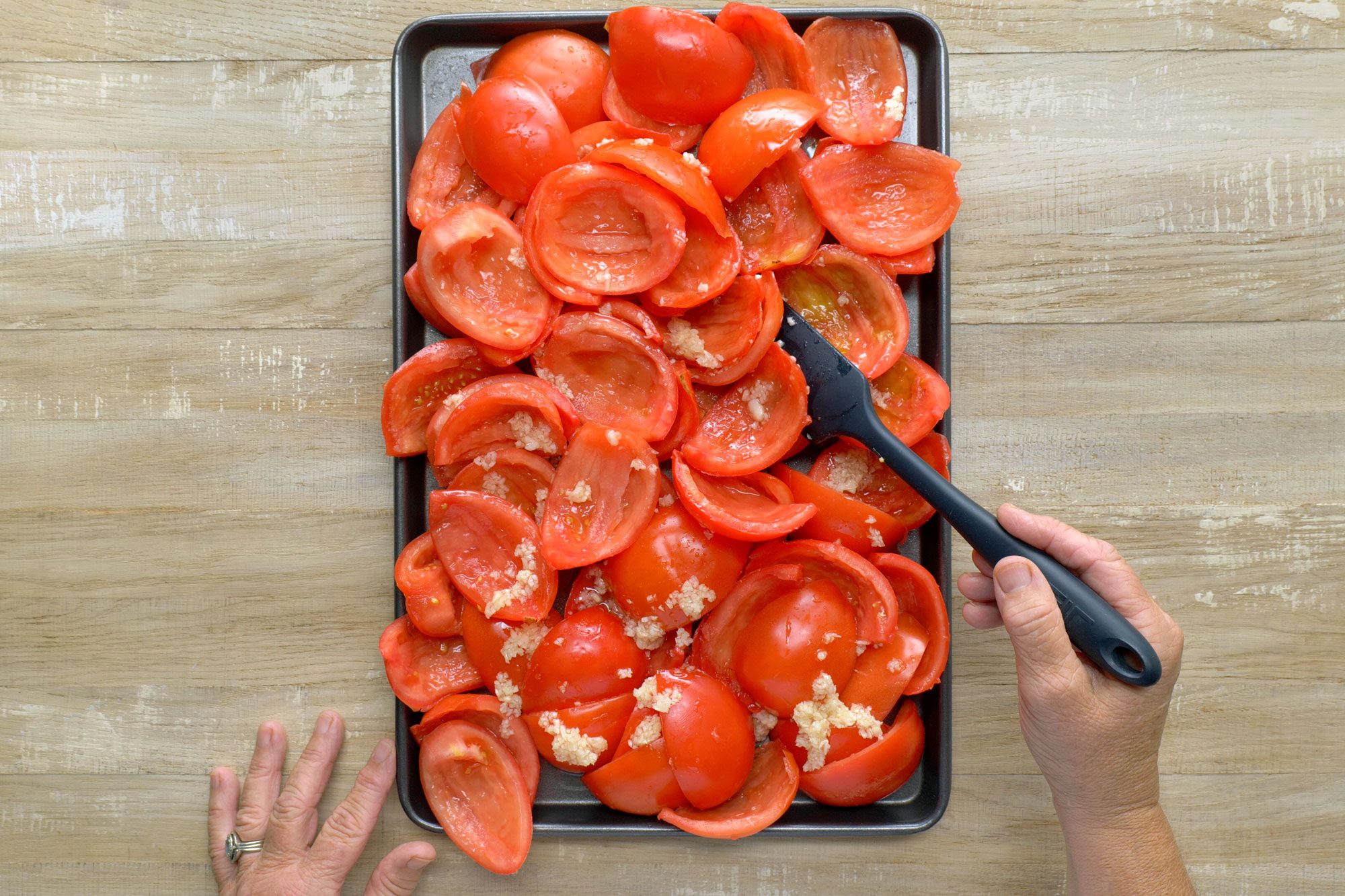 Place tomatoes in a greased baking pan; Wooden Background;