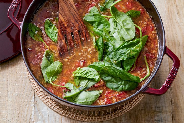 overhead shot; added in spinach until wilted in the large bowl