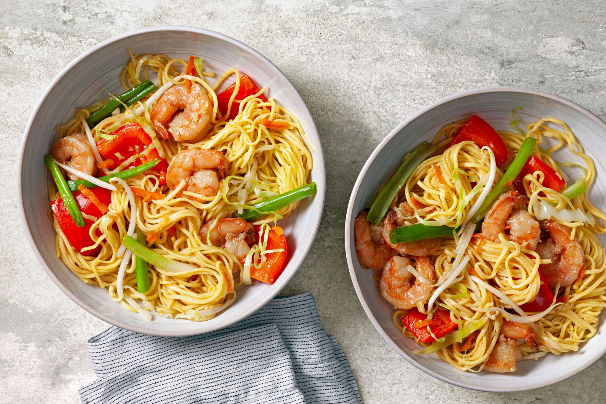 Shrimp Chow Mein served in two bowls with napkin on the side