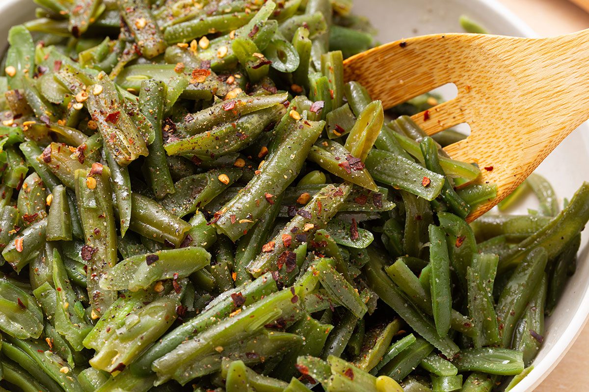 Close up of french style green in a bowl for Slow Cooker Green Bean recipe for Taste of Home