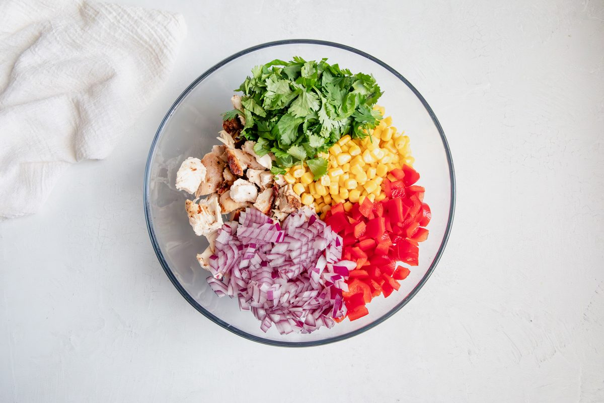 Overhead shot for Taste of Home Southwest Chicken Salad, ingredients in a glass bowl before being mixed.