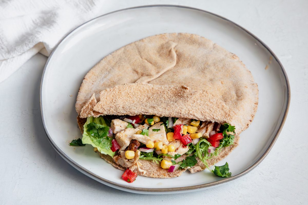 Beauty Shot for Taste of Home Southwest Chicken Salad in a pita with salad greens on a plate. 