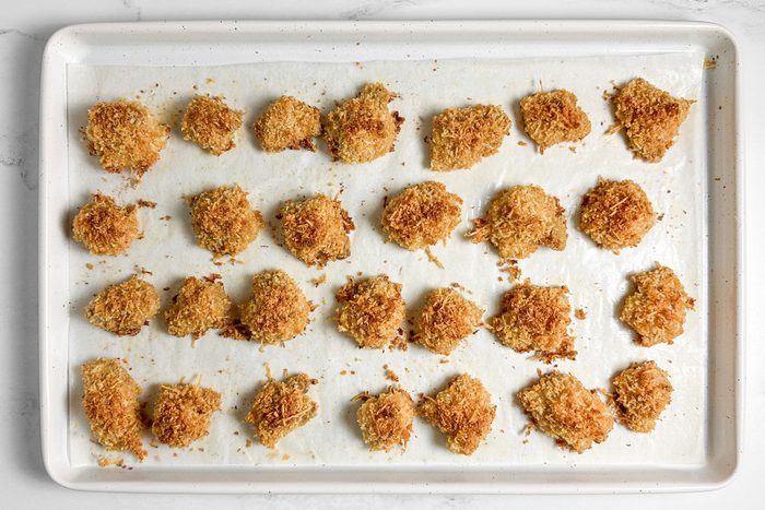 Taste of Home Spicy Chicken Nuggets on a white baking sheet