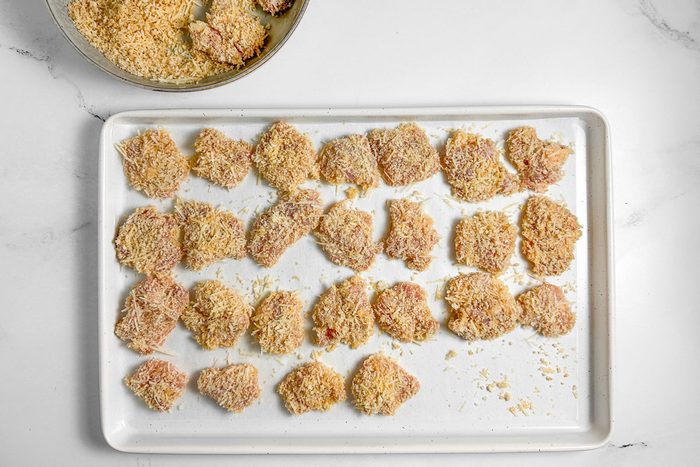 Breaded Taste of Home Spicy Chicken Nuggets on a white baking sheet