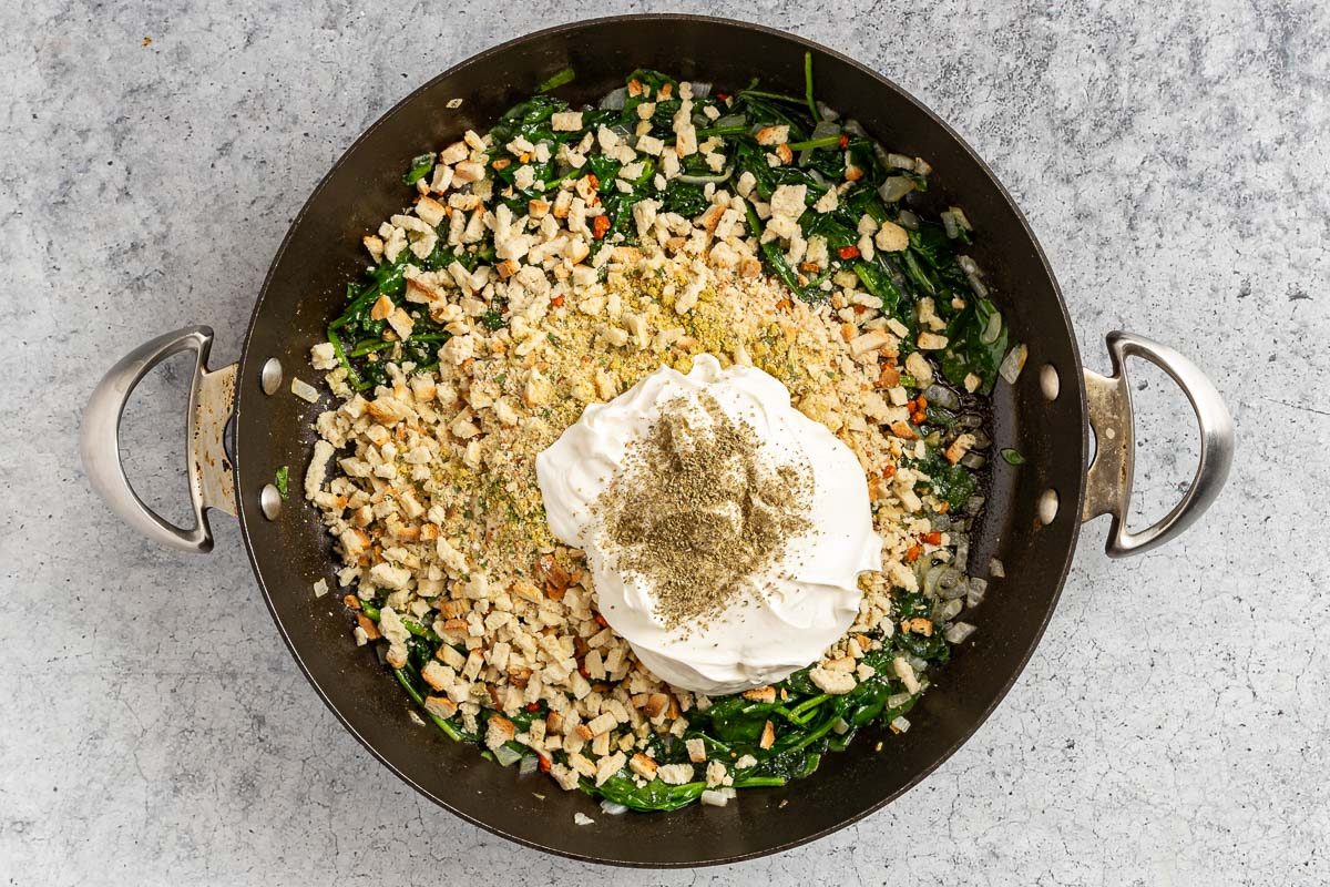 Taste of Home Stuffed Pork Chops photo of the sage stuffing mix, sour cream, and sage rub added to the skillet.