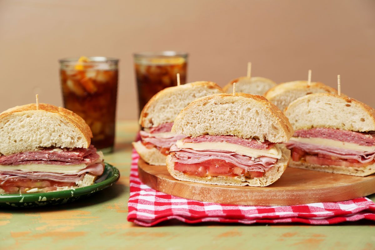 Close up of Taste of Home's Italian Sub on a wooden board with a red gingham towel.
