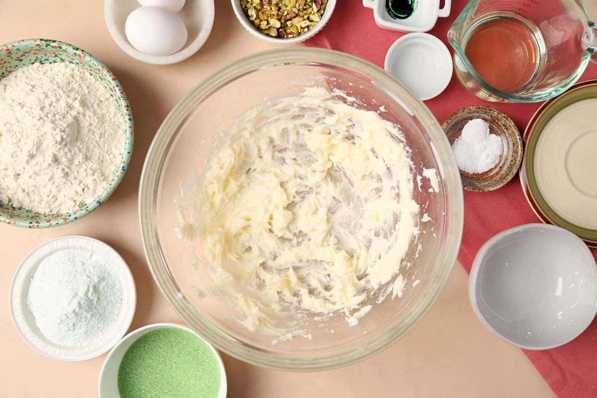 The process of making Taste of Home's Pistachio Cookies. Creaming together butter, oil and powdered sugar.