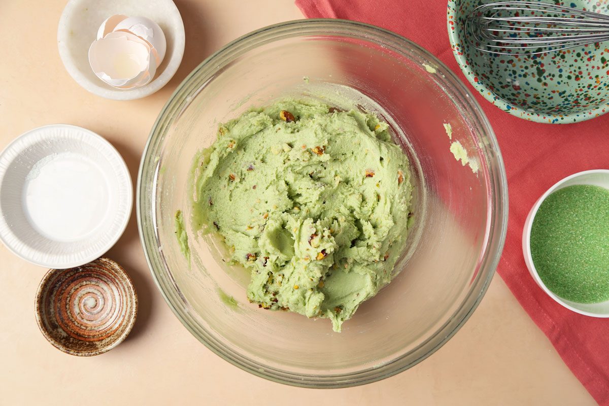 The process of making Taste of Home's Pistachio Cookies. Cookie dough in a large bowl ready to be chilled.
