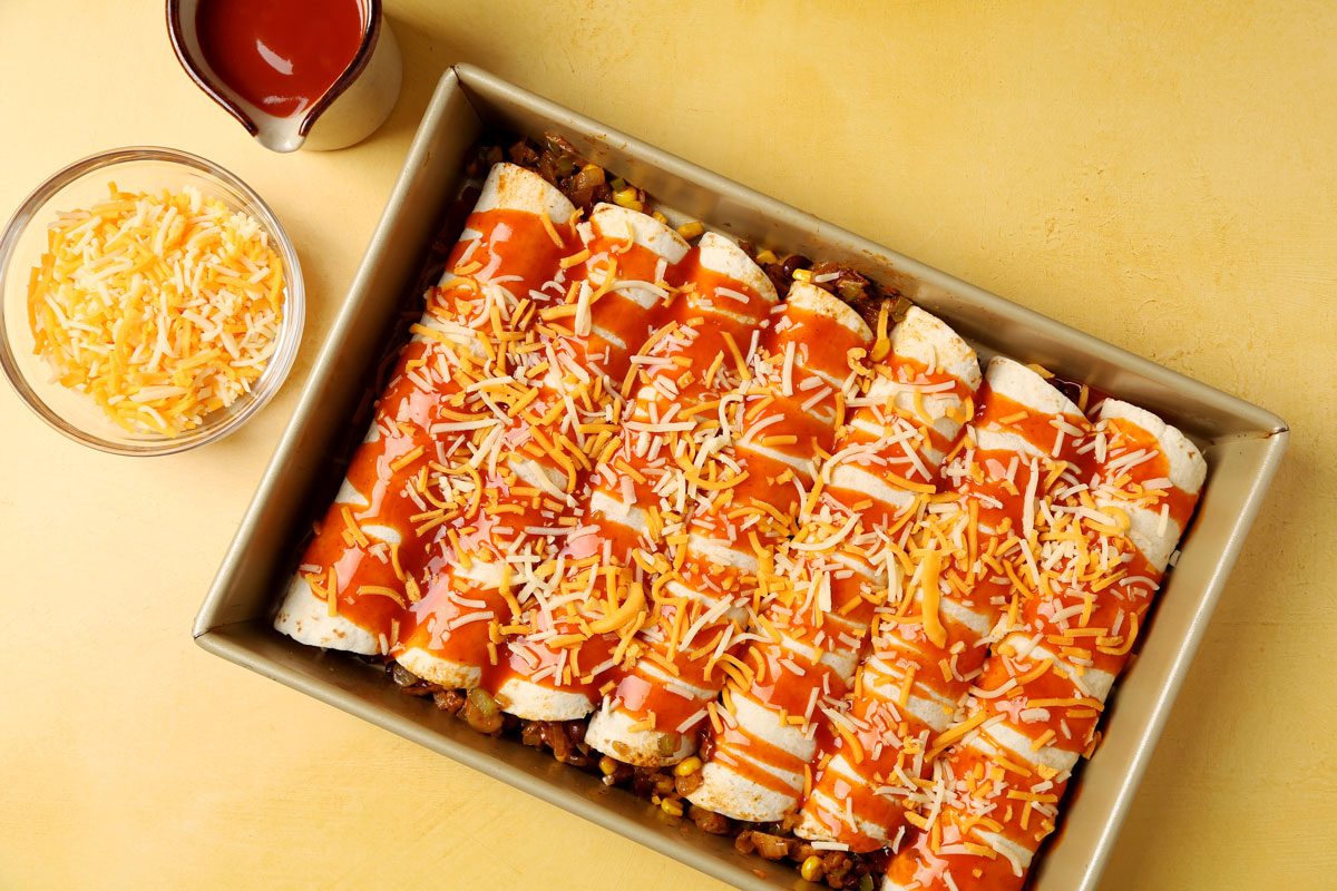 Making Taste of Home's Vegetarian Enchiladas with different ingredients laid out on a yellow surface.