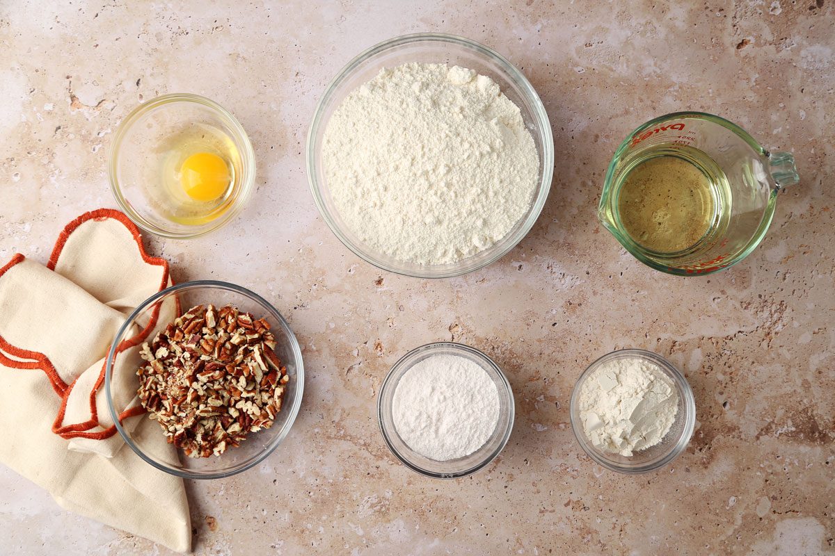 Ingredients for Taste of Home's Butterscotch Cookies laid out in small bowls on a brown marble surface.
