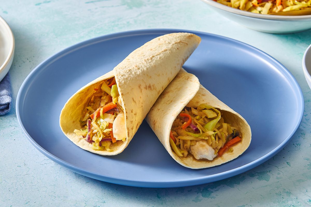 Closeup shot of two Thai chicken wraps on a plate