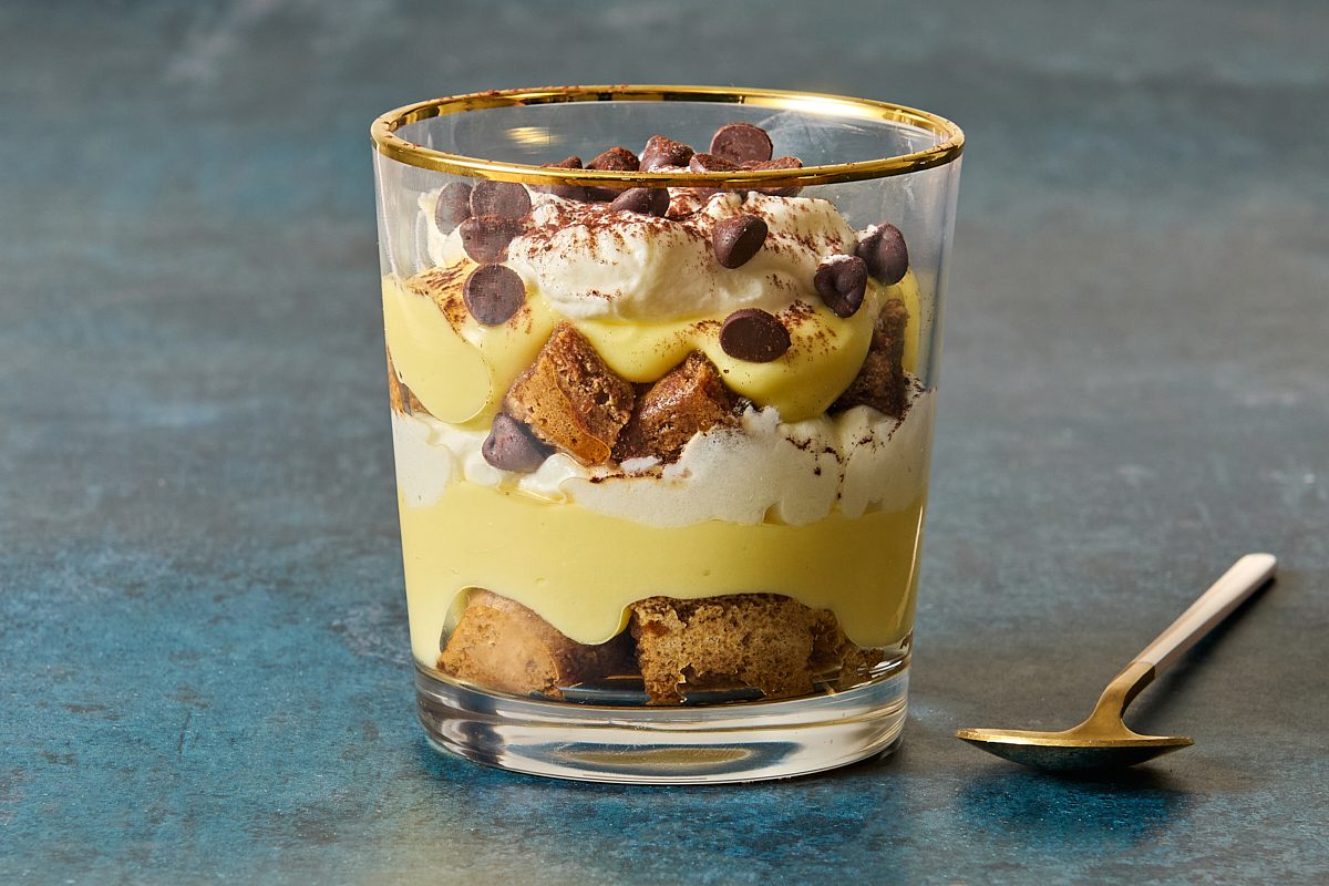 Closeup shot of a tiramisu cup from the side showing all of the layers