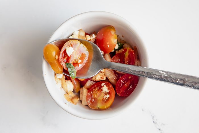 Close up beauty shot for Taste of Home Tomato Feta Salad being served in a bowl.