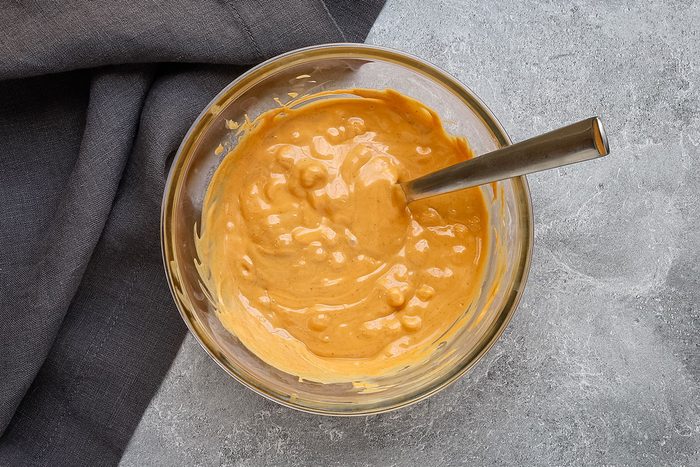 Melting the butterscotch chips and peanut butter for tumbleweed dessert.