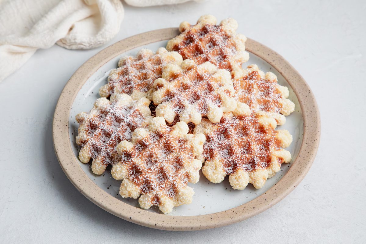 Close up beauty shot for Taste of Home Waffle Cookies on a plate on a marble surface.