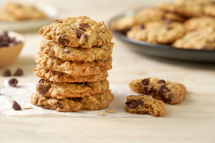 Close-up horizontal shot of the Taste of Home Air Fryer Oatmeal Cookies, Stacked and highlighting the the crispy edges, with melted chocolate chips visible.