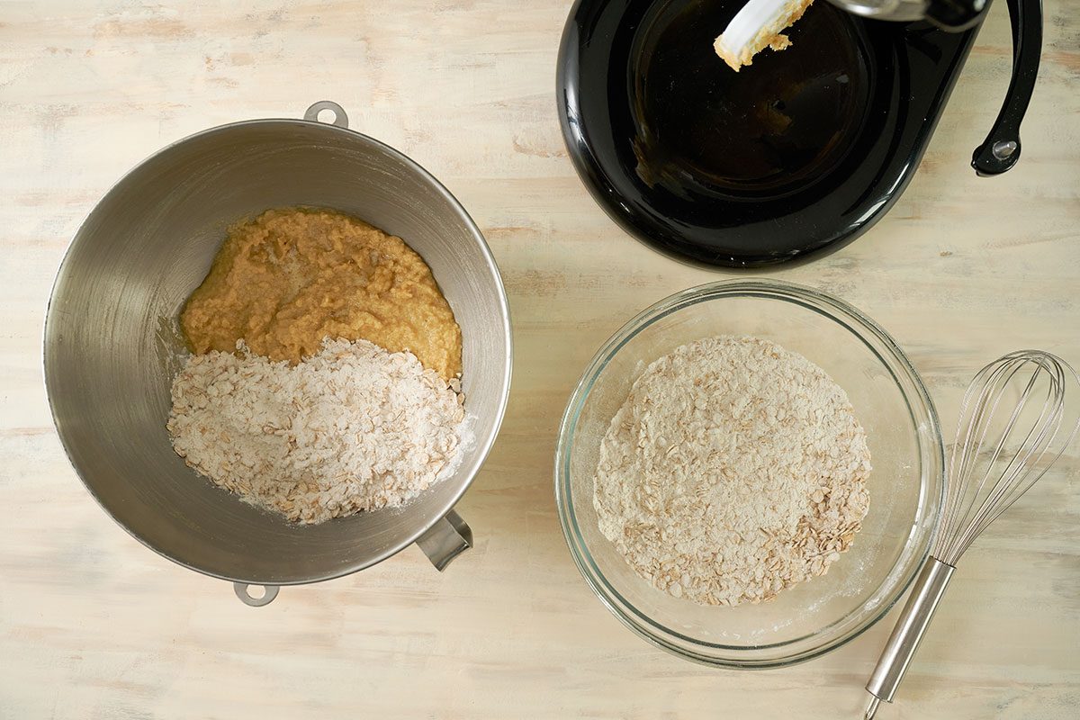 Overhead view of the dry ingredients being gradually mixed into the creamed butter mixture, forming the oatmeal cookie dough for the Taste of Home Air Fryer Oatmeal Cookies recipe.