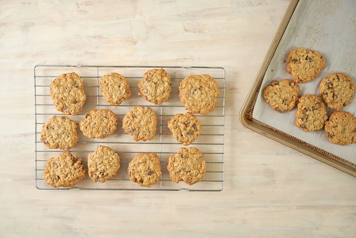 Overhead view of the fully cooked Taste of Home Air Fryer Oatmeal Cookies, cooling on a wire rack, golden brown and ready to serve.