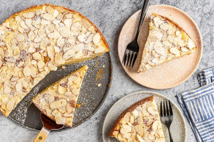 Taste of Home Almond Ricotta Cake photo of the finished recipe cut into slices and served on plates.