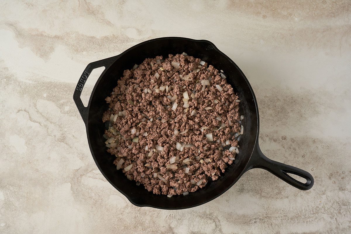 Preheat the oven to 350°F. In a large skillet, cook the beef, onion, and garlic until the meat is no longer pink and the onion is soft for this Baked Chili Spaghetti by Taste of Home.