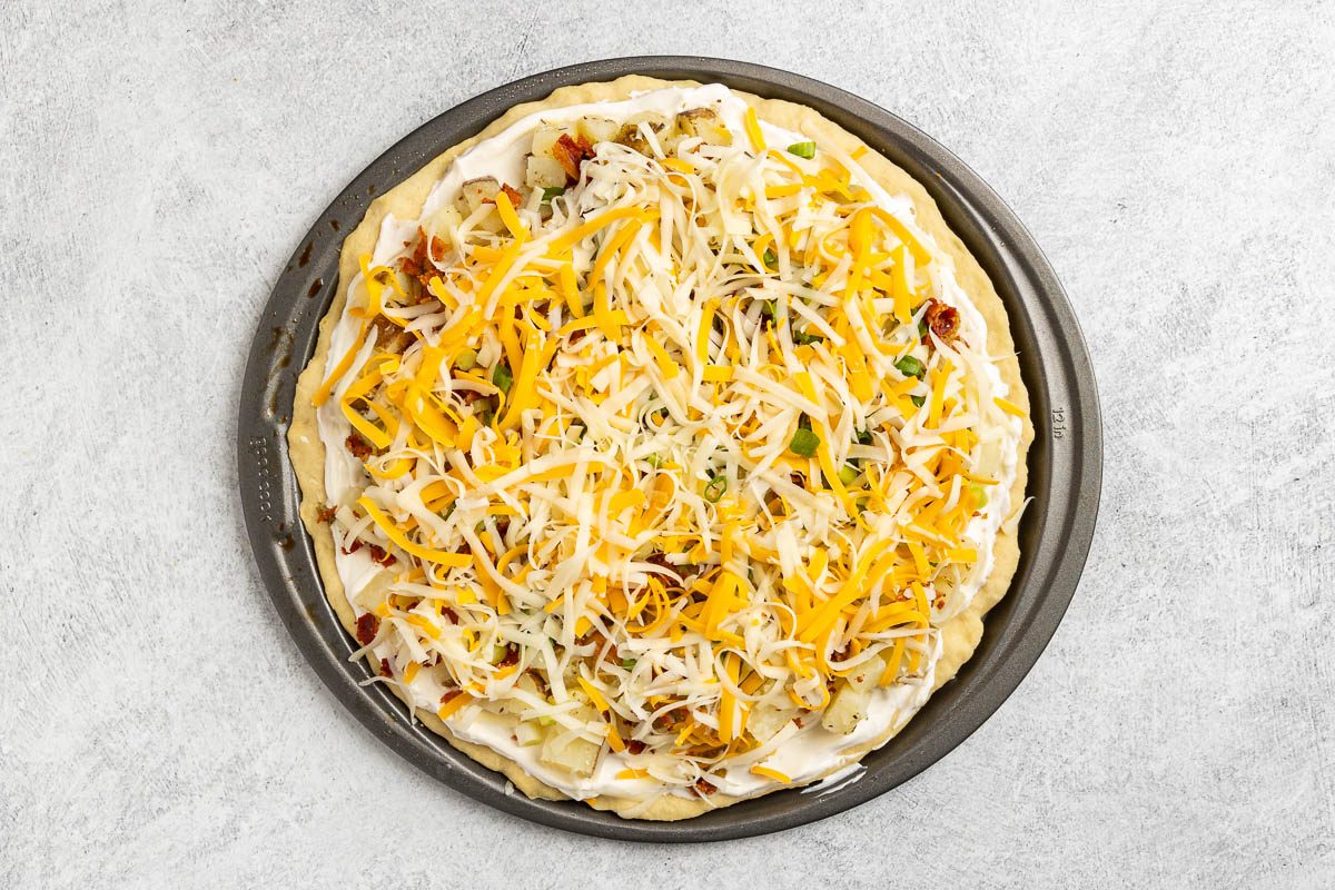 Taste of Home Baked Potato Pizza photo of assembling the pizza.