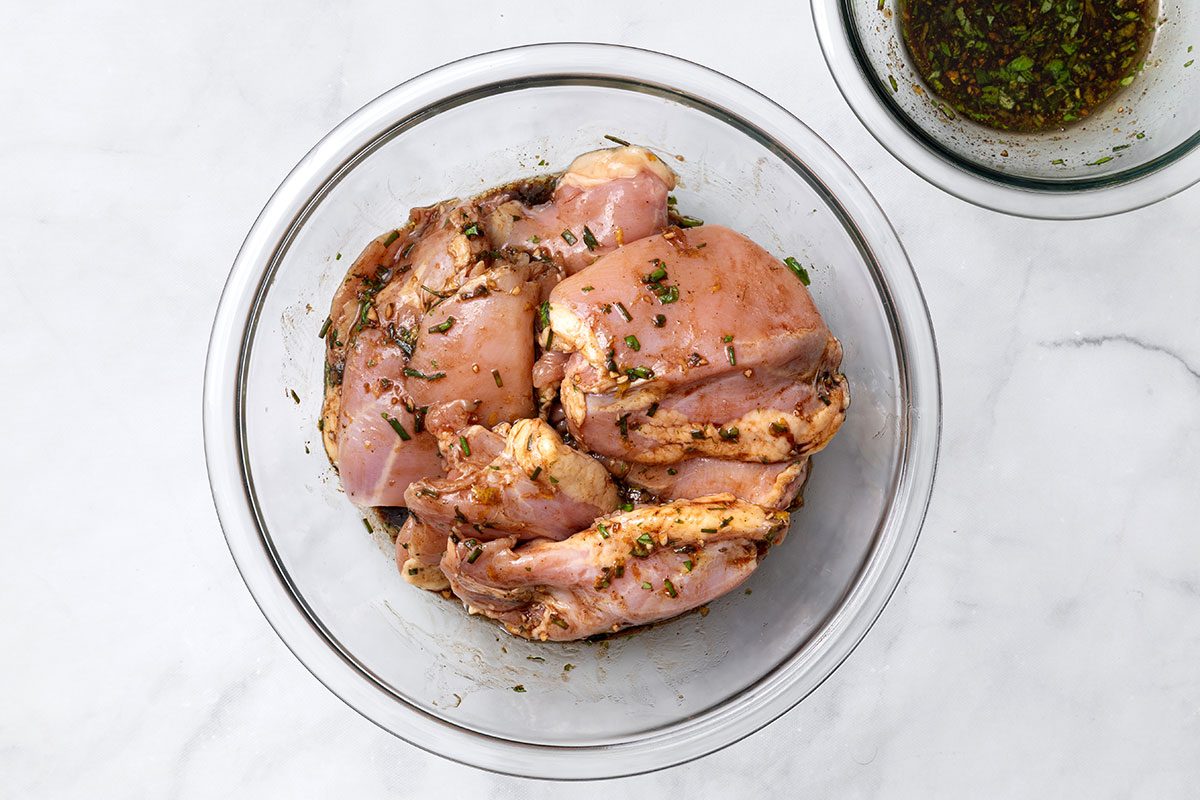 Chicken thighs tossed in balsamic vinegar sauce mixture for step one of Balsamic Chicken recipe for Taste of Home