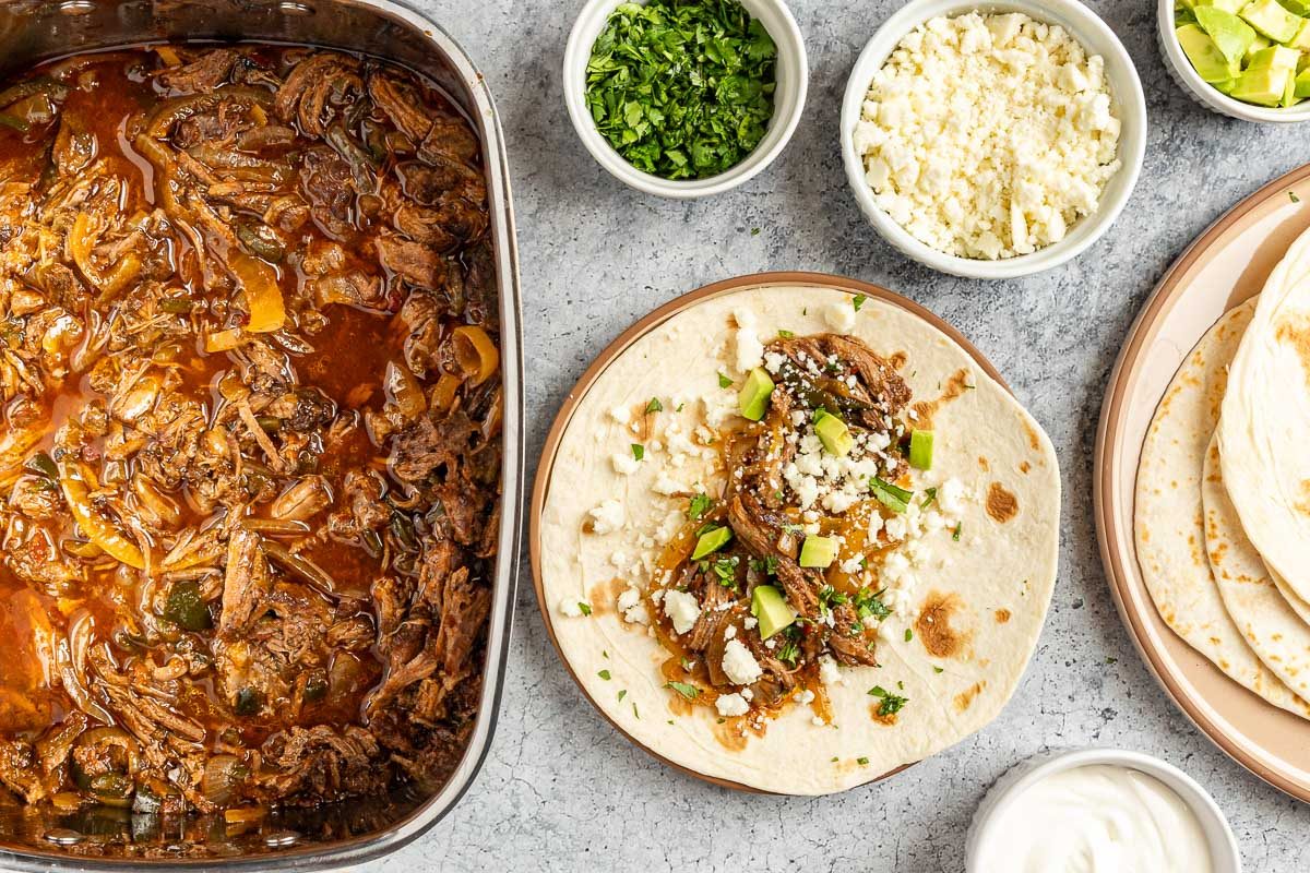 Taste of Home Beef Carnitas photo of building the beef carnitas tacos.
