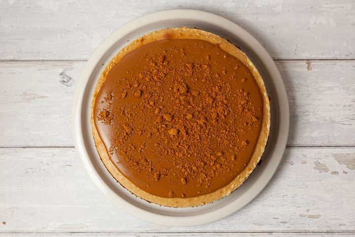 Step 5 of Taste of Home Biscoff Cheesecake is top with cookie sprad and crumbs