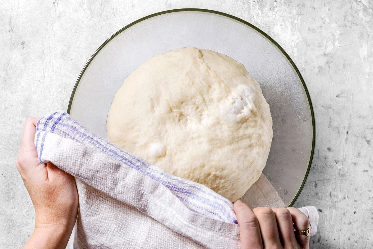 Transfer Dough To A Greased Bowl. Cover With Towel;