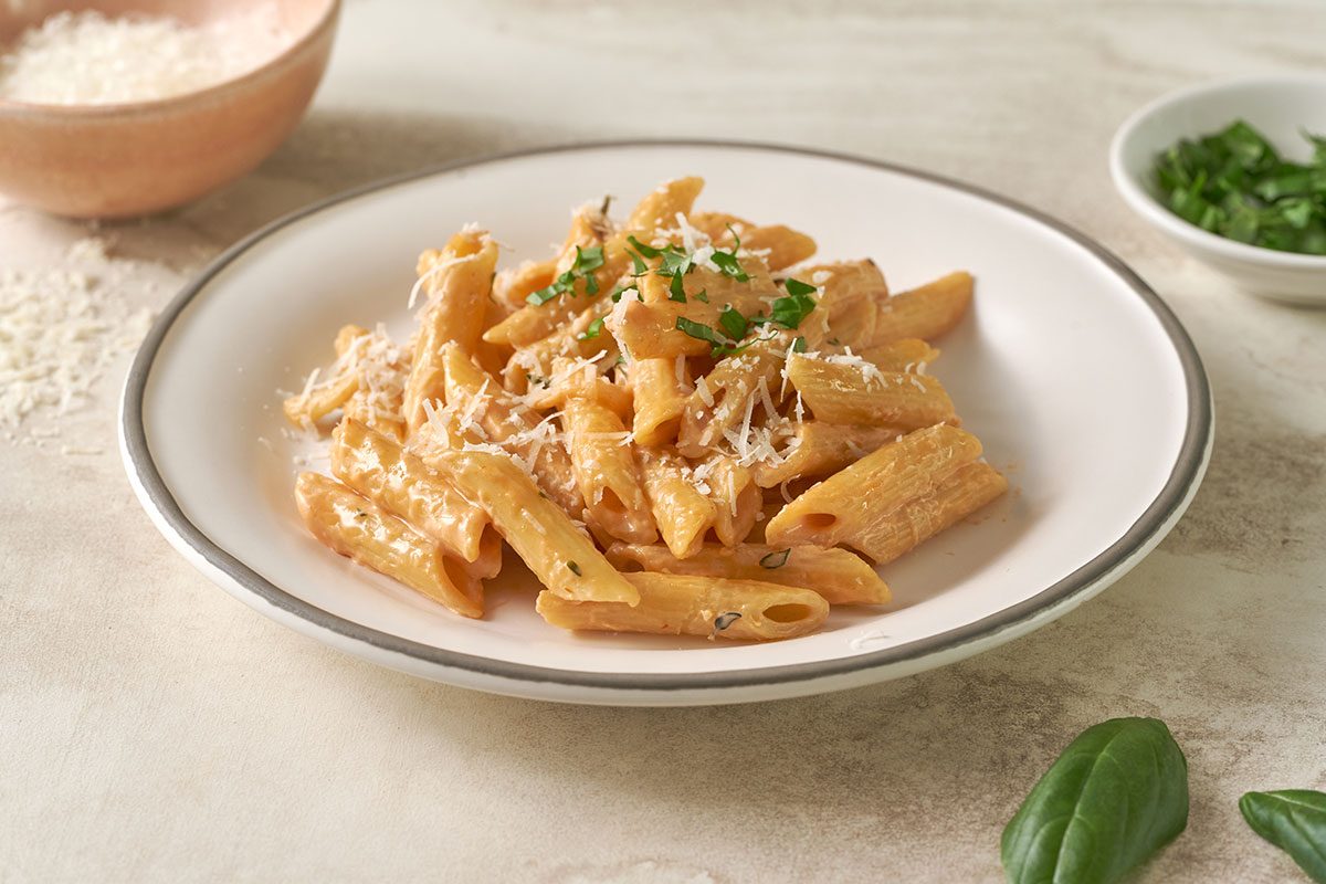 A close-up shot of the Creamy Pasta, highlighting the rich cream sauce, cheese, and perfectly cooked pasta.