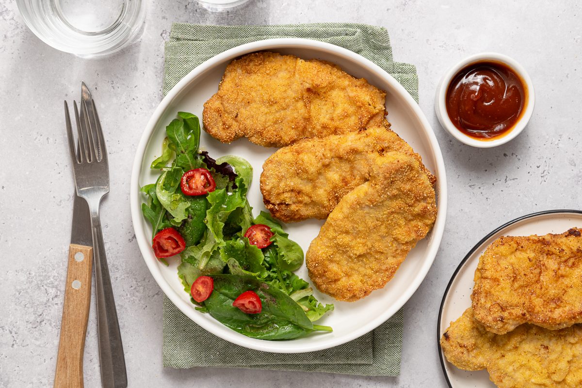 Breaded Pork Tenderloins And Green Salad With Barbecue Sauce