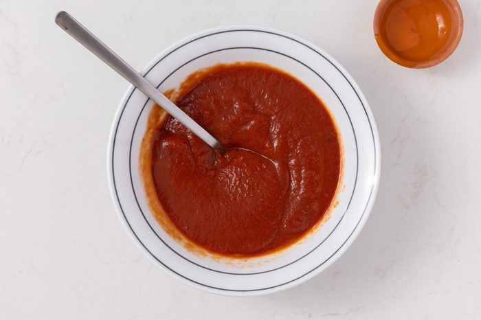 Calzone sauce being mixed in small bowl.