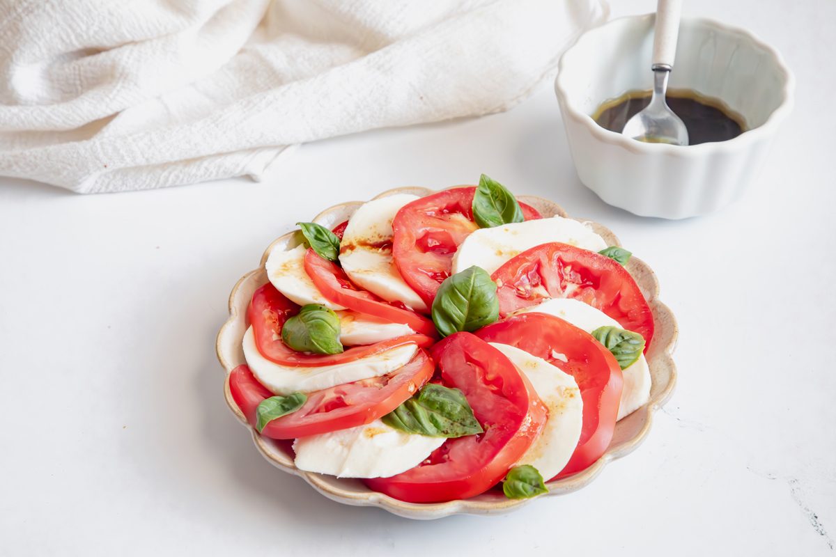 Beauty shot for Taste of Home Caprese Salad with ingredients assembled on a plate.