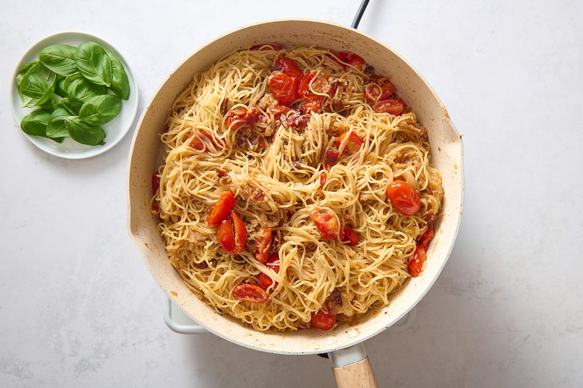 Adding the remaining ingredients to the pan before serving