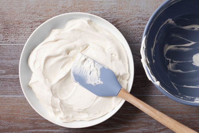 Cream cheese mixture poured into an empty dish and spread in an even layer