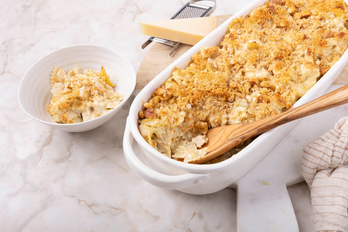 Chicken Artichoke Casserole 3/4 view with wooden spoon